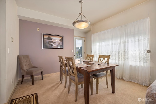 dining space featuring light colored carpet