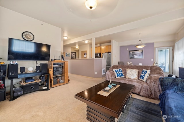 living room with ceiling fan and light colored carpet