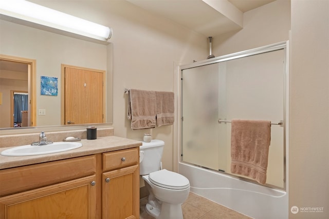 full bathroom featuring bath / shower combo with glass door, vanity, toilet, and tile patterned floors