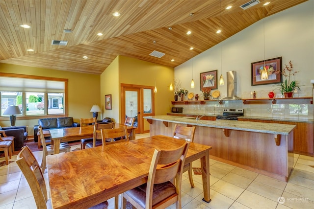 dining space with high vaulted ceiling, wooden ceiling, light tile patterned flooring, and french doors