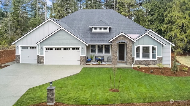 craftsman-style house featuring a front yard and a garage