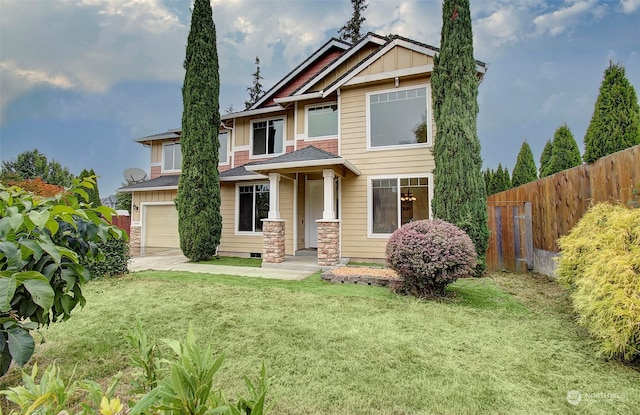 view of front of home featuring a garage and a front yard