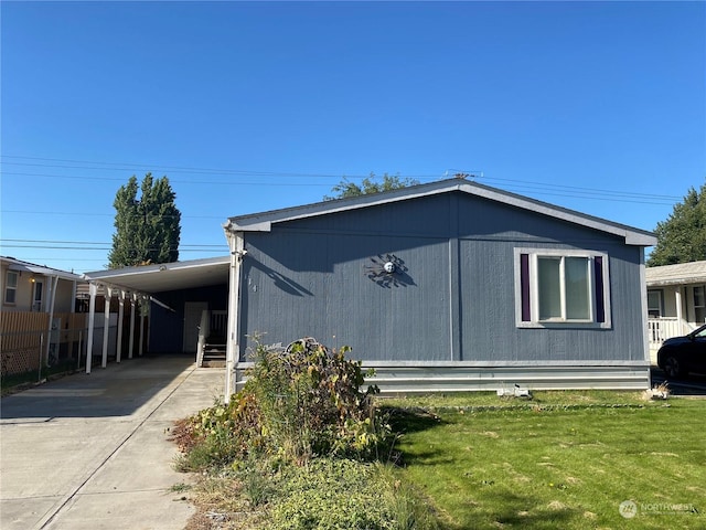 view of home's exterior with a carport, a yard, fence, and driveway