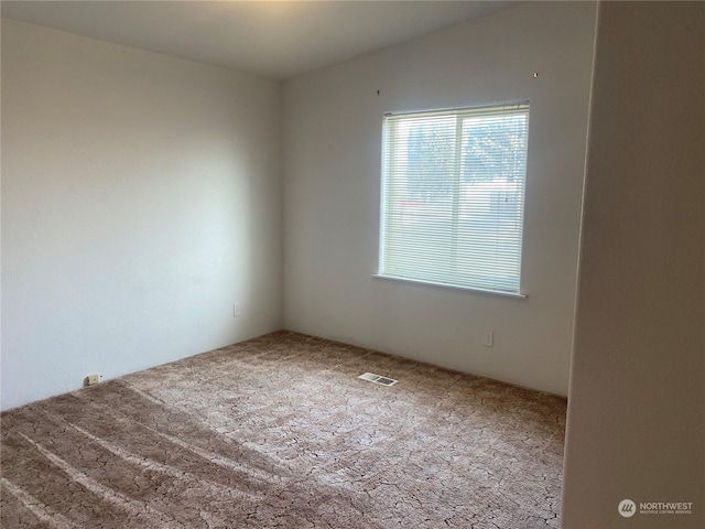 carpeted empty room with visible vents