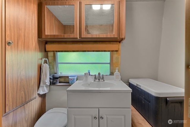 bathroom featuring vanity and toilet