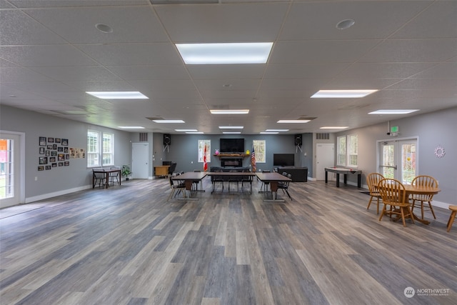 living room with hardwood / wood-style floors and a paneled ceiling