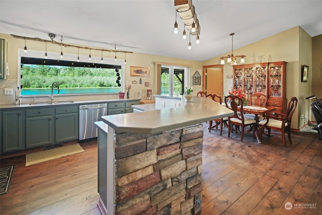 kitchen featuring dishwasher, an inviting chandelier, vaulted ceiling, sink, and wood-type flooring