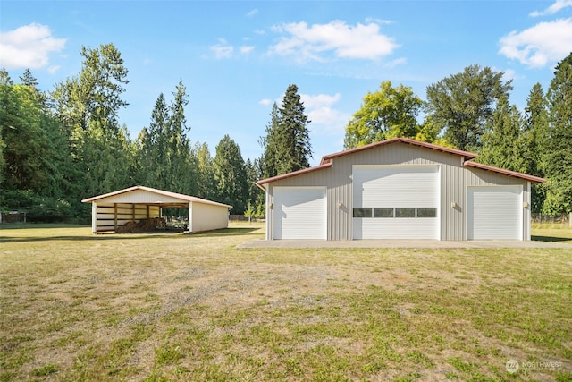 garage featuring a yard and a carport