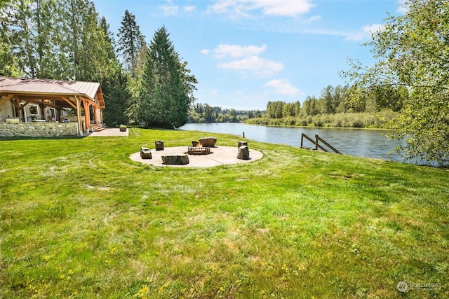 view of yard with a fire pit, a patio area, and a water view