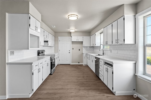 kitchen with sink, appliances with stainless steel finishes, white cabinetry, and decorative backsplash