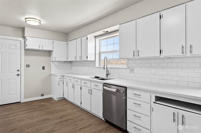 kitchen featuring white cabinets, dishwasher, hardwood / wood-style floors, sink, and decorative backsplash