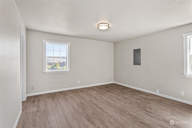 spare room with hardwood / wood-style flooring and a textured ceiling