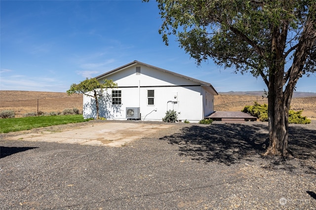 view of front of home featuring ac unit and a rural view