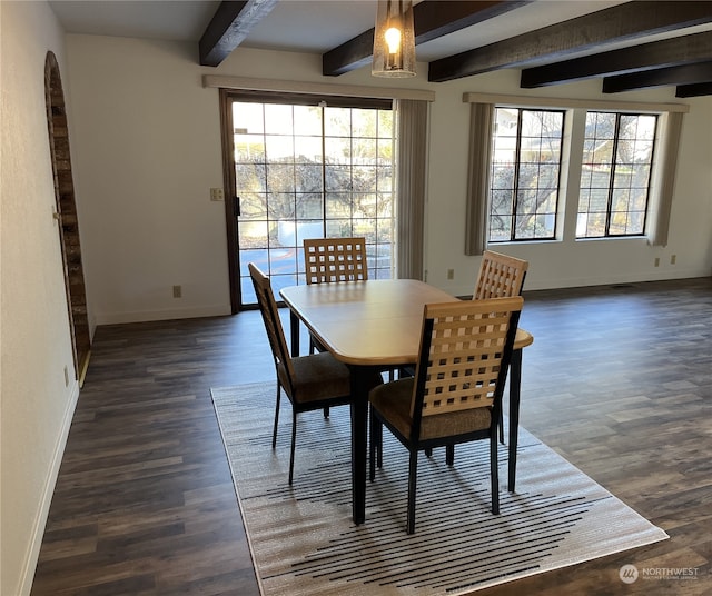 dining area with beam ceiling and dark hardwood / wood-style flooring