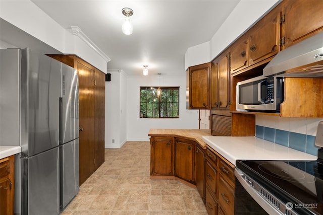 kitchen with appliances with stainless steel finishes and tasteful backsplash