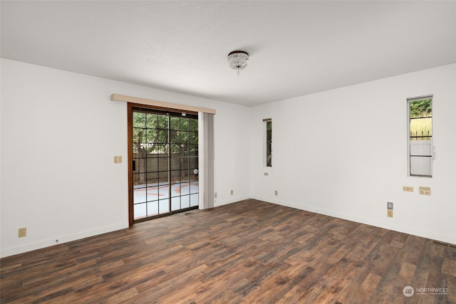 unfurnished room featuring dark wood-type flooring