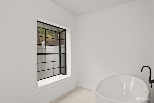 interior space with tile patterned flooring and a tub