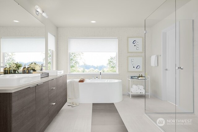 bathroom with a tub, tile patterned flooring, and vanity