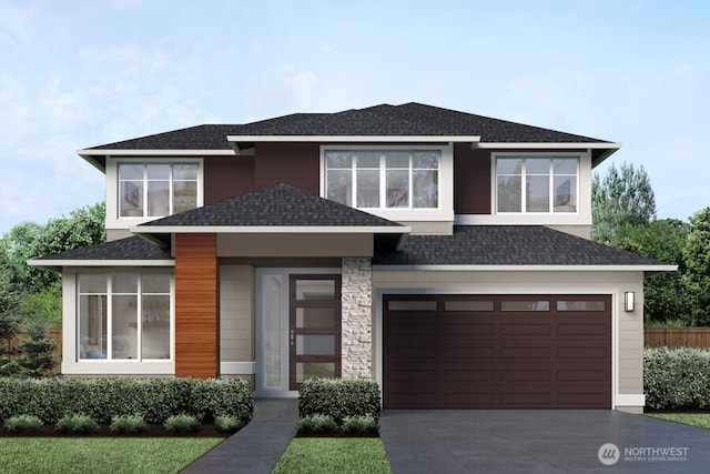 view of front of property with roof with shingles, concrete driveway, and an attached garage