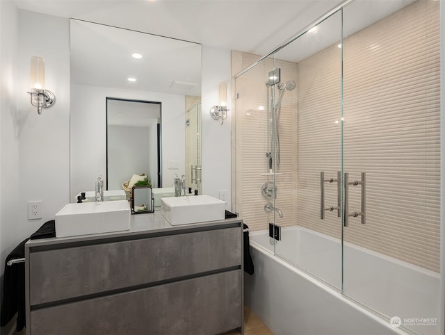 bathroom with vanity and combined bath / shower with glass door