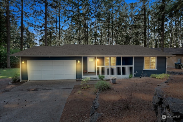 ranch-style home featuring a garage and covered porch