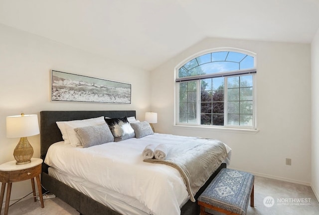 carpeted bedroom featuring lofted ceiling