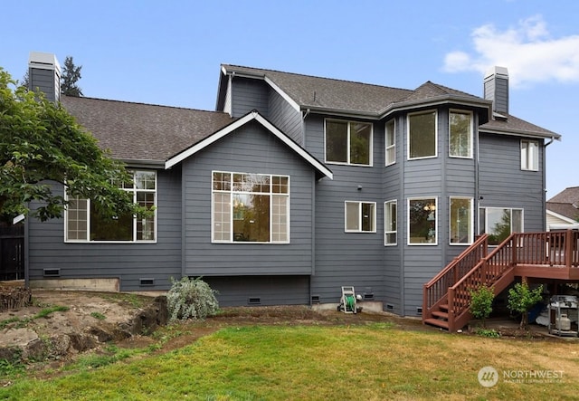 back of property featuring a wooden deck and a lawn