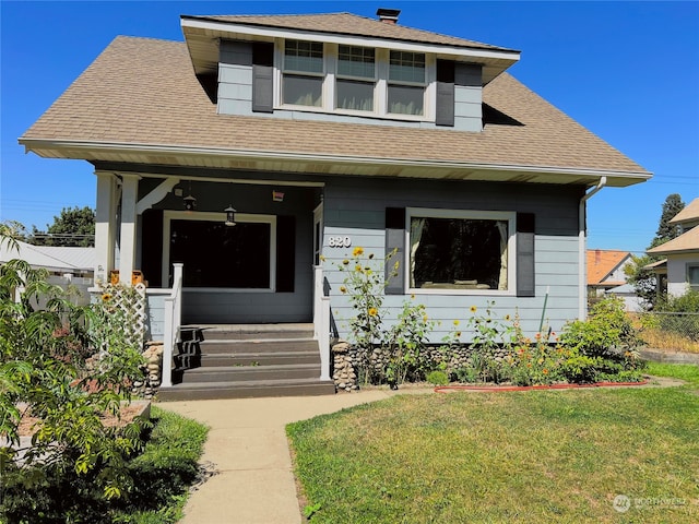 view of front of house featuring a porch and a front lawn