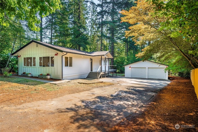 ranch-style home featuring board and batten siding, an outdoor structure, and a detached garage