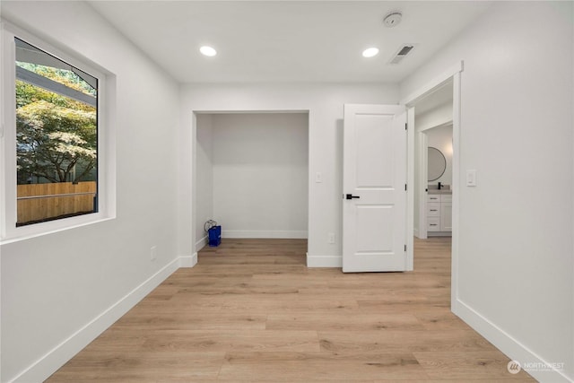 interior space with light wood finished floors, recessed lighting, visible vents, and baseboards