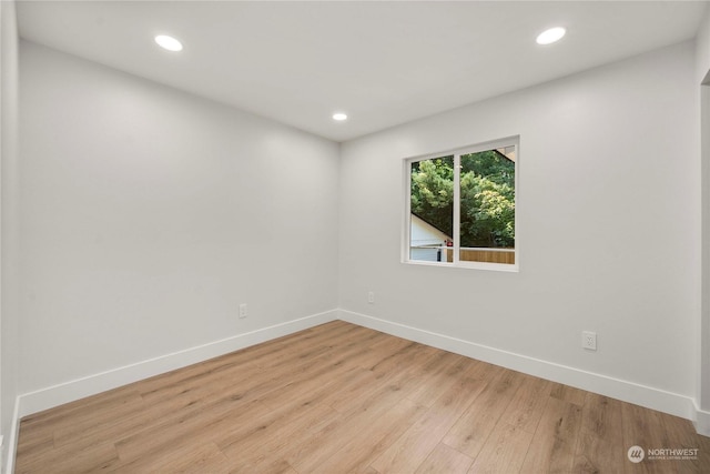 spare room with recessed lighting, light wood-style flooring, and baseboards