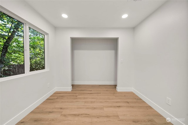 unfurnished bedroom with light wood-style flooring, baseboards, and recessed lighting