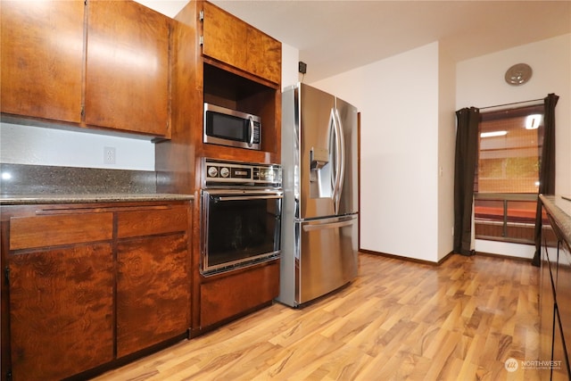 kitchen with light wood-type flooring and stainless steel appliances