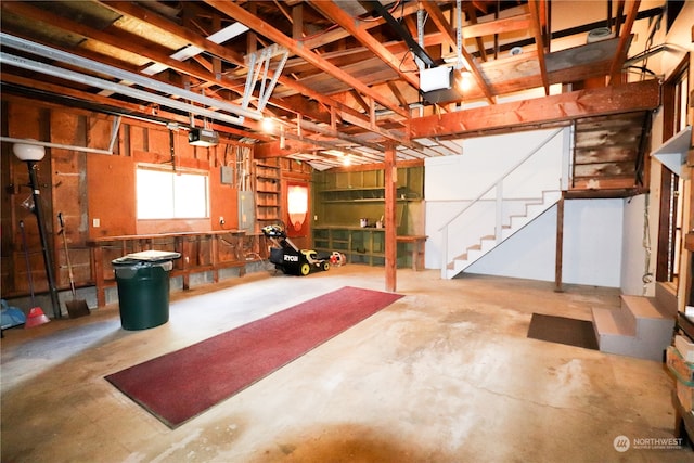 garage with electric panel and a garage door opener