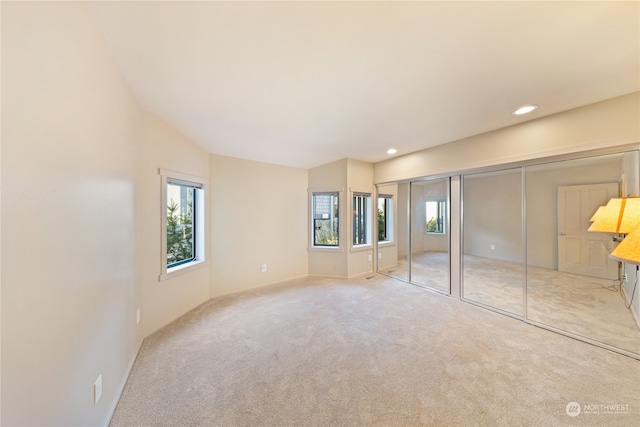 unfurnished bedroom featuring light carpet