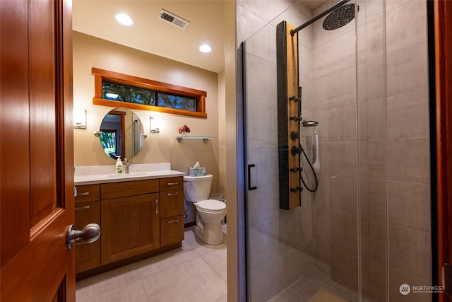 bathroom featuring vanity, toilet, and a shower with door