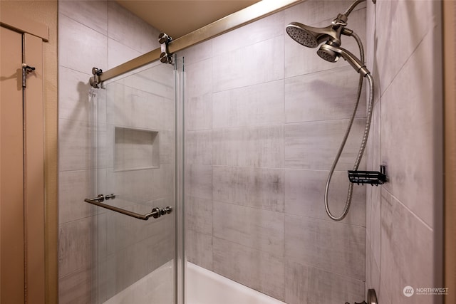 bathroom featuring a shower with door