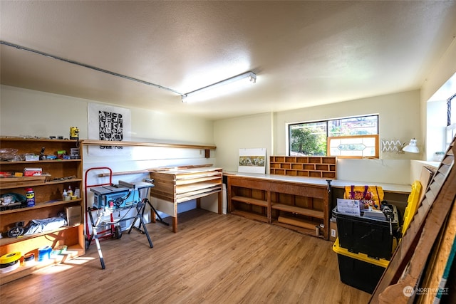 miscellaneous room featuring track lighting, hardwood / wood-style flooring, and a textured ceiling