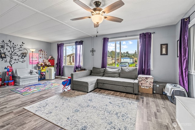 living area with ceiling fan and wood finished floors