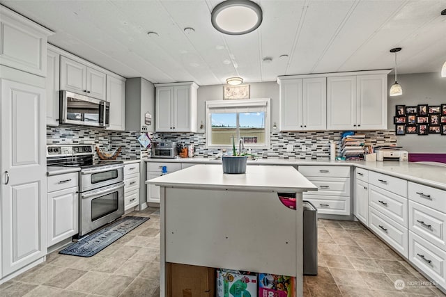 kitchen featuring white cabinetry, appliances with stainless steel finishes, light countertops, and decorative backsplash