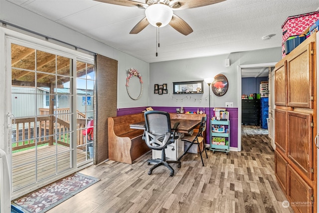 office with light wood finished floors and a ceiling fan