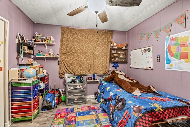 bedroom featuring wood finished floors and a ceiling fan