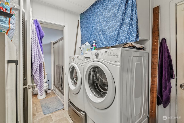 clothes washing area featuring washer and dryer and laundry area