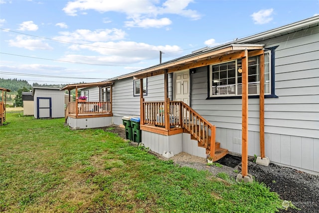 rear view of property featuring a storage shed, a lawn, and an outdoor structure