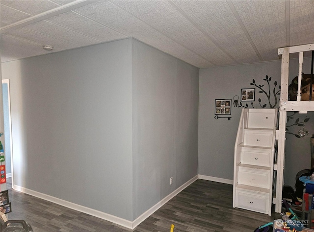 interior space featuring baseboards and dark wood finished floors