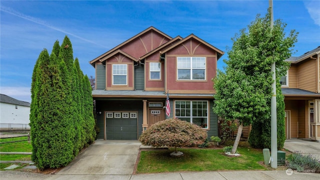 view of front of home with concrete driveway, an attached garage, fence, and a front yard