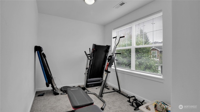 workout area with visible vents, baseboards, and carpet