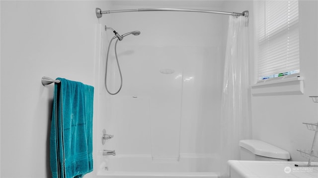 bathroom with toilet and shower / bath combo