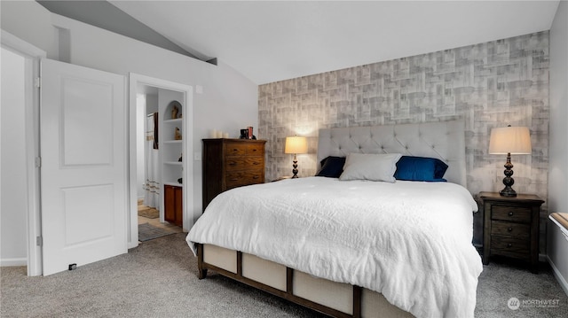 carpeted bedroom with baseboards, connected bathroom, wallpapered walls, and lofted ceiling