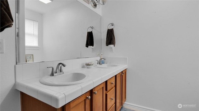 bathroom featuring double vanity and a sink